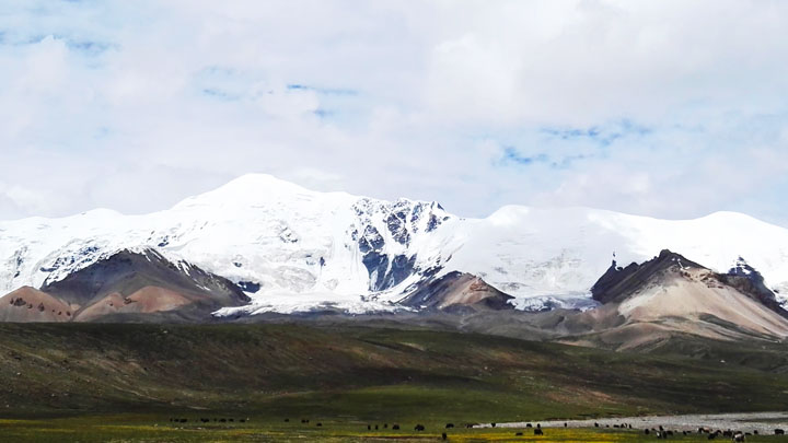 Grasslands below the peaks of Amne Machin Snow Mountain.