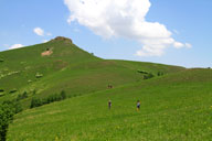 Clouds over the green rolling hills of the Bashang Grasslands