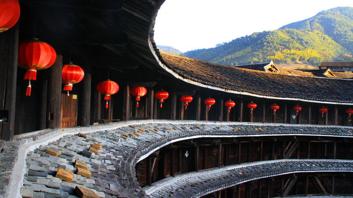 Lanterns line the balcony of a tulou building