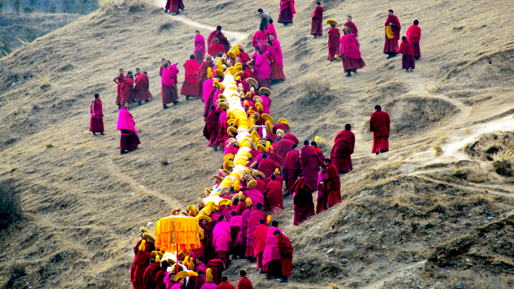 Monks carrying the thangka