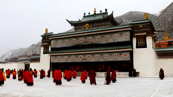 Monks gather outside the hall of a monastery