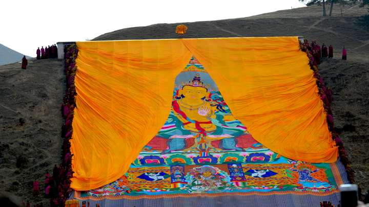 Monks begin to unveil the Buddha