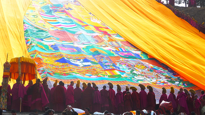 Monks unveiling a huge cloth thangka