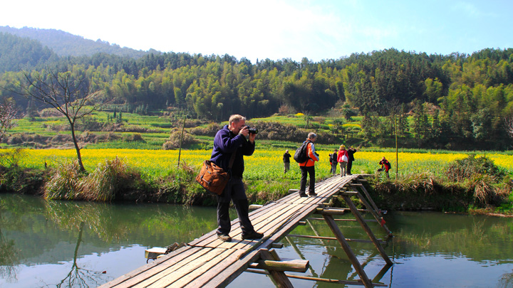 Crossing a small bridge while walking between villages