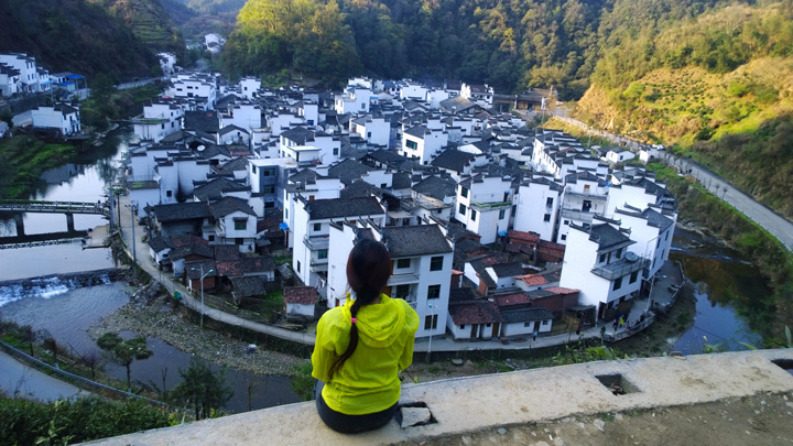 A river wraps around a village in Wuyuan